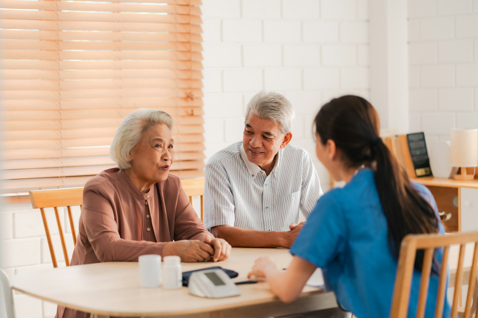 health insurance service young asian caregiver nurse examine senior man or woman patient at home 1.jpg