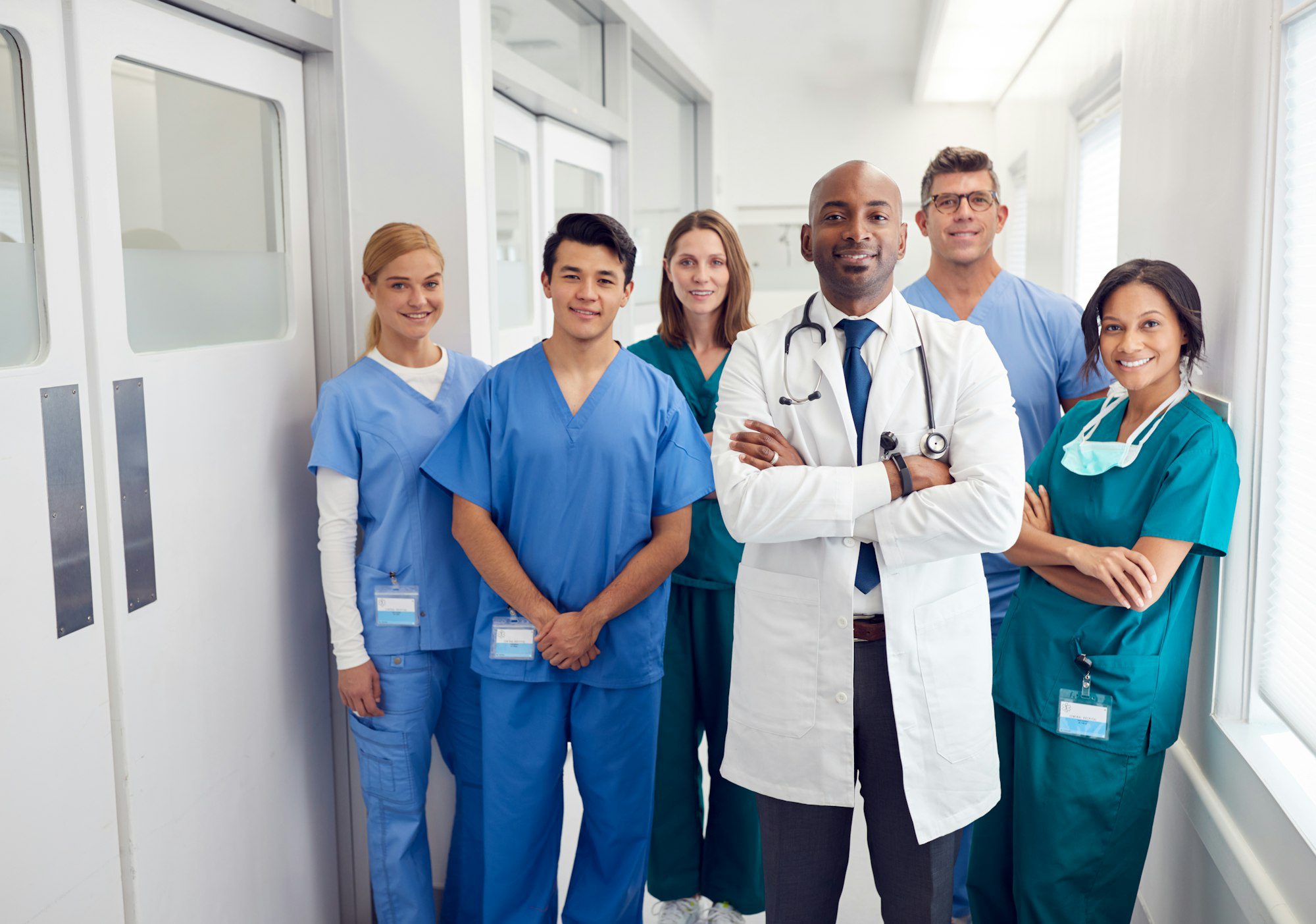 portrait of multi cultural medical team standing in hospital corridor.jpg